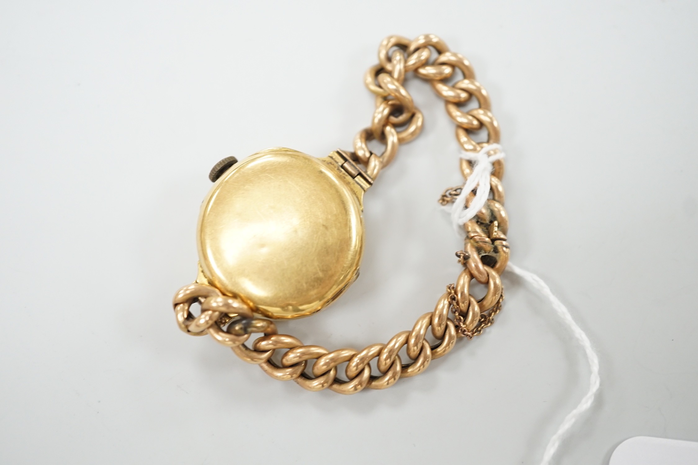 An early 20th century 18ct gold manual wind wrist watch, with Arabic dial, case diameter 27mm, on a yellow metal (stamped 15) curblink bracelet